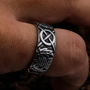 Vintage stainless steel cross ring with sun flower carvings on a male model finger