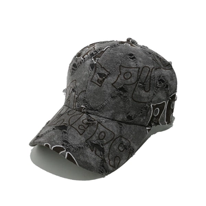 Detailed view of the distressed baseball cap featuring frayed holes and embroidery