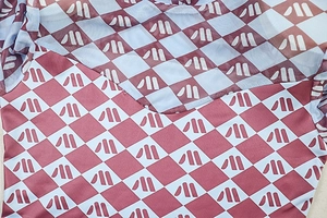 Detail of burgundy and blue checkered mesh fabric with sheer texture and seaming