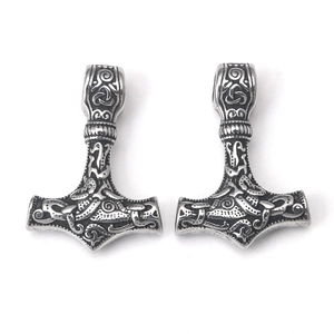 Detail of silver Thor's hammer pendant with intricate Nordic Viking relief patterns