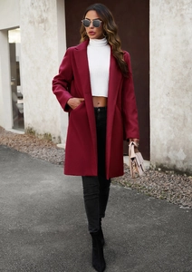 Street style shot of a long burgundy wool coat styled with a white top and black boots