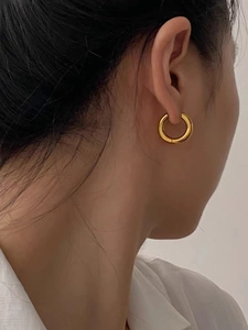 Classic gold hoop earrings in minimalist design worn for a clean daily look