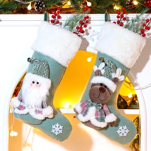 Detailed view of plush Christmas stockings with 3D Santa and reindeer hanging on fireplace