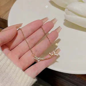 Elegant 18K gold-plated fishtail pendant necklace with zircons and white enamel accents