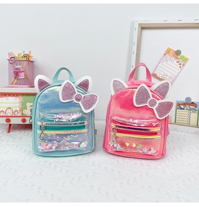 Detail of cute cat ears backpack with colorful sequins and a large glittery bow design