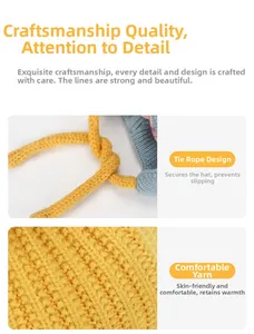 Detail of grey and yellow knit kid's hat showing thick yarn texture and tie ropes