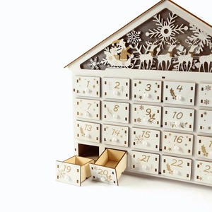 Wooden 24-day advent calendar house with Santa and reindeer carvings in white and wood