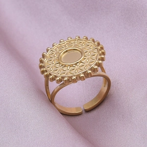 Detailed macro view of vintage golden stainless steel ring with geometric flower pattern