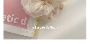 Detail of oversized mesh hair scrunchie with pink floral pattern on organza fabric