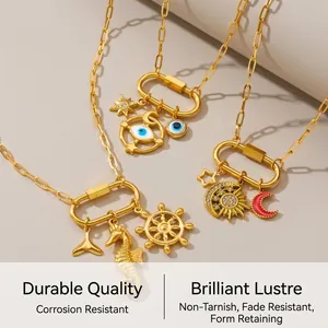 Detailed macro view of gold carabiner necklaces with sea star and moon charms