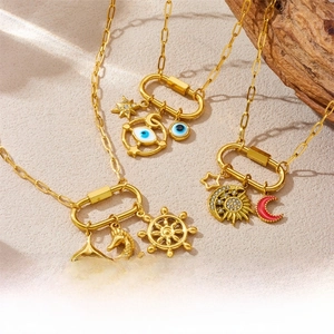 Detailed macro view of gold carabiner necklaces with sea star and moon charms
