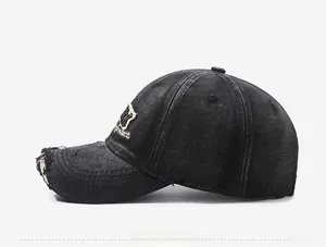 Side view of vintage washed denim baseball cap with distressed brim and embroidery