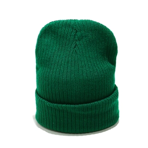 Close-up of dark green ribbed knit beanie showing textured vertical striped pattern
