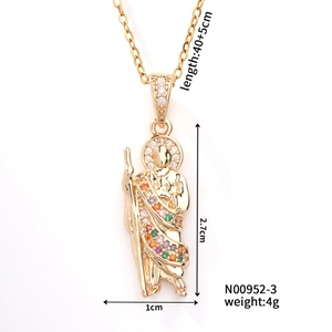 Macro detail of a gold priest pendant with colorful zircons and size measurements