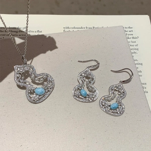 Macro view of zircon pearl gourd flower jewelry set including pendant necklace and earrings