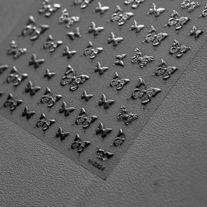 Detailed view of silver metallic butterfly nail art stickers with item number NO.2324