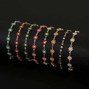 Chic gold daisy flower bracelets in eight vibrant colors displayed on a black stand