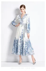 Close-up of V-neck floral print wrap dress with elegant blue paisley patterns and waist tie