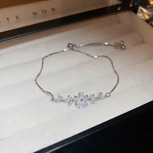 Adjustable silver flower bracelet with sparkling cubic zirconia in a jewelry gift box