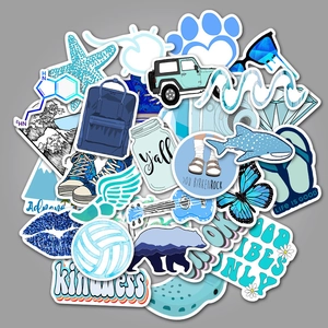 Flat lay of blue aesthetic waterproof stickers featuring jeep, whale and vibes quotes