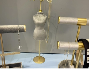 Detailed set of grey velvet jewelry display stands with gold metal bases and necklace bust