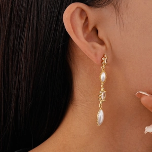 Close-up of elegant French vintage tassel earrings with pearls and zircon on model