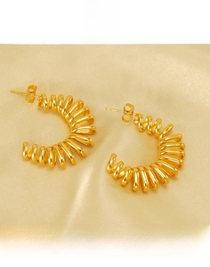 Detailed macro view of 18k gold plated titanium steel spring style hoop earrings