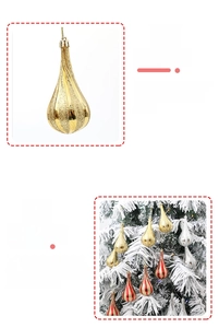 Detail of hanging teardrop Christmas ornaments in gold and silver on snowy tree branch