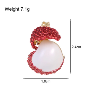 Elegant lychee fruit brooch with red textured shell and white pearl center on white background