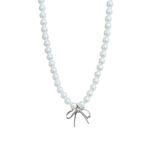 Minimalist pearl necklace featuring a silver bow pendant and elegant white round beads