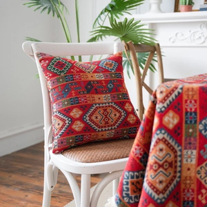 Ethnic red jacquard tablecloth and pillow set on a chair in a cozy home setting