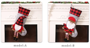 Hanging Christmas stockings with gnome embroidery and festive red plaid patterns on a fireplace