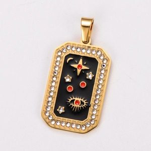 Close-up of golden tarot pendant with black enamel star, moon, and crystal border
