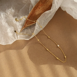 Minimalist 18K gold plated titanium necklace featuring natural freshwater pearls and beads