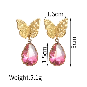 Detailed view of butterfly-shaped gold-tone earrings with pink crystals and dimensions