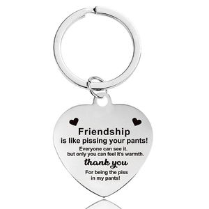 Close-up of heart-shaped stainless steel keychain with funny friendship engraving