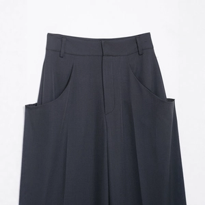 Deep charcoal grey wide-leg trousers featuring unique curved large pockets and a tailored waist