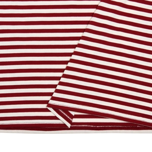 Close-up of red and white striped knit fabric showing high-quality overlock stitching detail