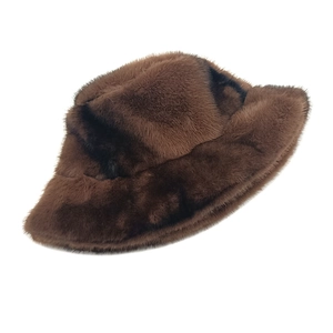 Detail of soft brown faux fur bucket hat with dense texture and glossy finish for winter
