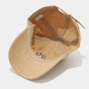 Detailed interior of khaki cotton baseball cap showing 100% cotton label and reinforced seams