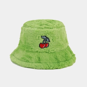 Detailed view of lime green plush bucket hat with red cherry embroidery pattern