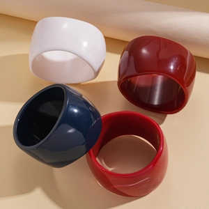 Minimalist wide resin bangles in solid colors and marble texture for a chic retro style