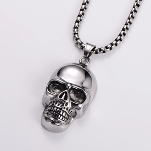 Detailed view of punk style silver skull pendant with polished stainless steel chain