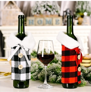 Detail of Christmas wine bottle covers with red plaid fabric, fur collar and wood buttons
