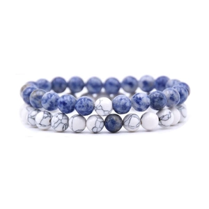 Detail view of 8mm blue lapis and white spotted stone elastic bead bracelets set