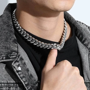 Close-up of 12mm silver stainless steel Cuban link chain necklace worn on a male model
