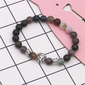 Detailed close-up of a silver lion head charm with natural stone beads on a bracelet