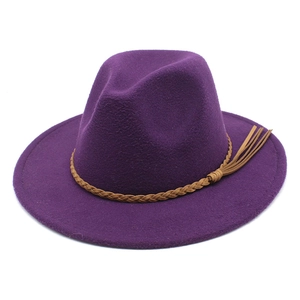 Detail of purple fedora hat with brown braided leather band and decorative tassels