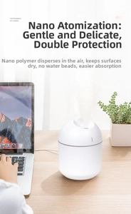 Detail of white mini USB humidifier with nano-mist on an office desk next to a laptop