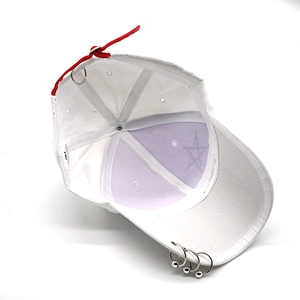 Detail of white baseball cap showing purple star lining and silver metal rings